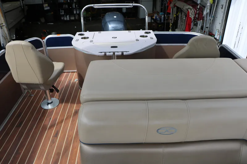 Slide: The Image of 2014 Xcursion X23F pontoon boat interior with beige seating and wood flooring. - 49