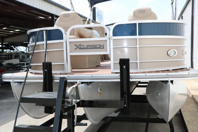 Slide: The Image of 2014 Xcursion X23F pontoon boat on trailer in storage facility. - 5