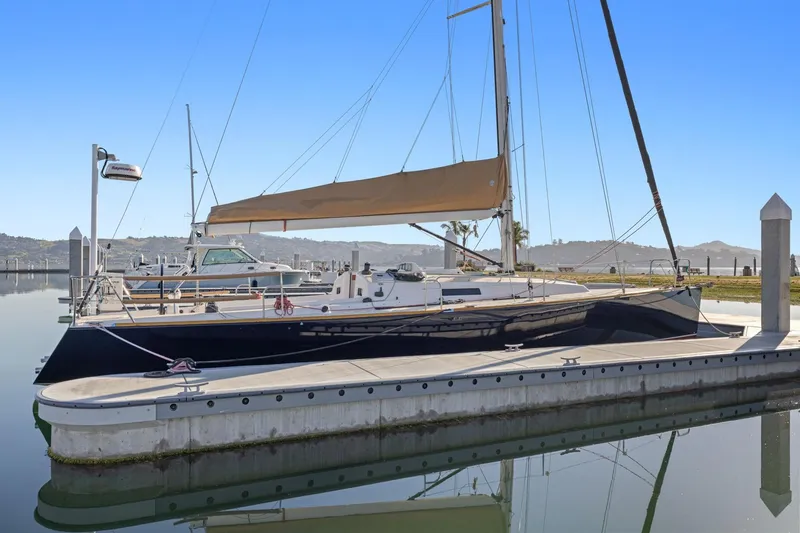 Slide: The Image of 2005 J Boats J/124 sailboat docked at a marina under clear blue skies. - 1