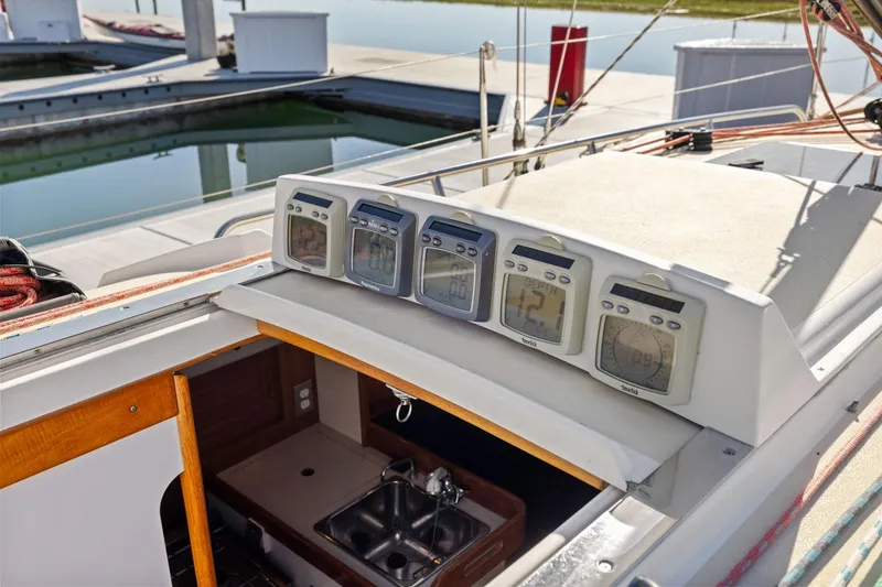 Slide: The Image of Cockpit instruments on a 2005 J Boats J/124 sailboat, docked at a marina. - 11