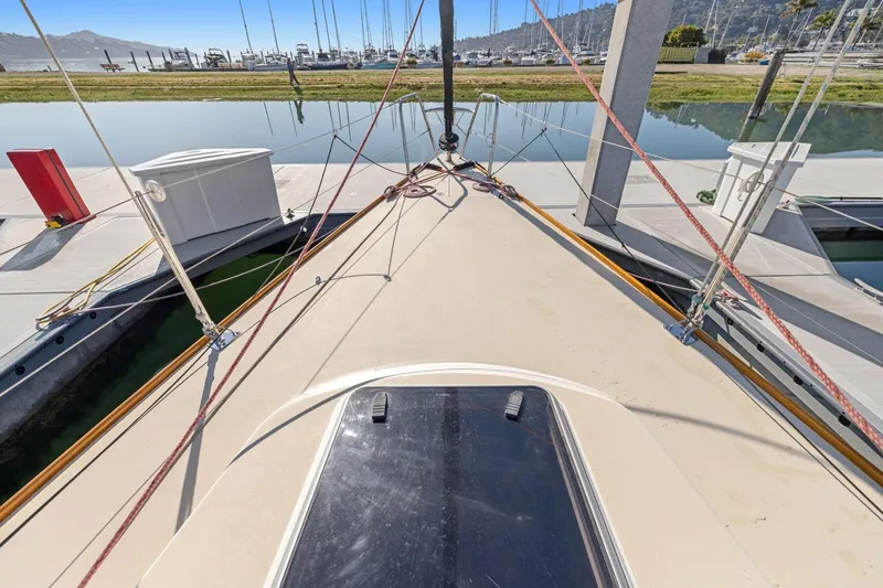 Slide: The Image of 2005 J Boats J/124 sailboat docked at marina, showing deck and rigging. - 15