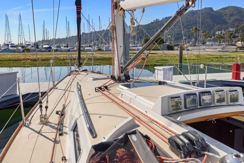 Slide: The Image of 2005 J Boats J/124 sailboat deck with marina view, featuring navigation instruments. - 16