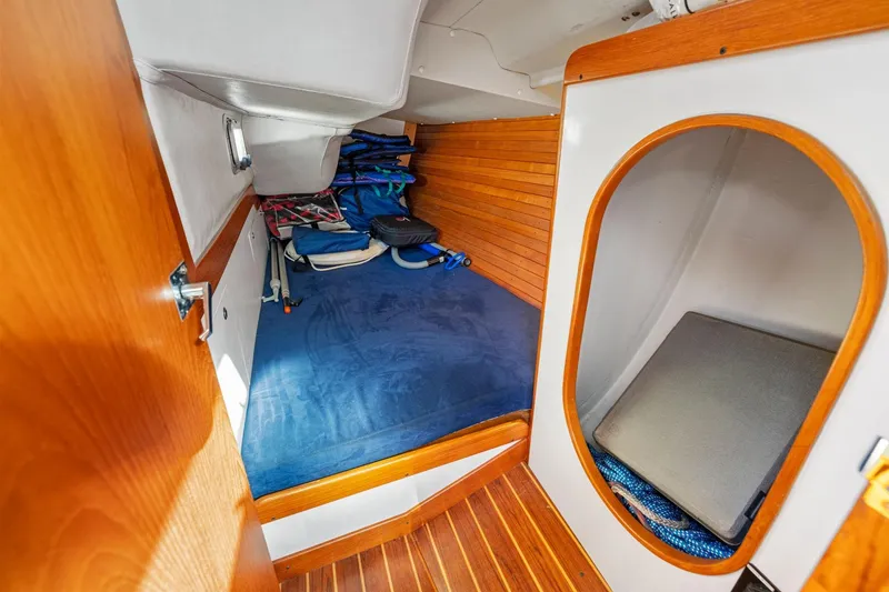 Slide: The Image of Cozy cabin interior of 2005 J Boats J/124, featuring wooden accents and storage space. - 19