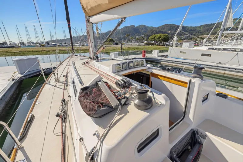 Slide: The Image of 2005 J Boats J/124 sailboat docked at marina, showcasing deck and cockpit. - 27
