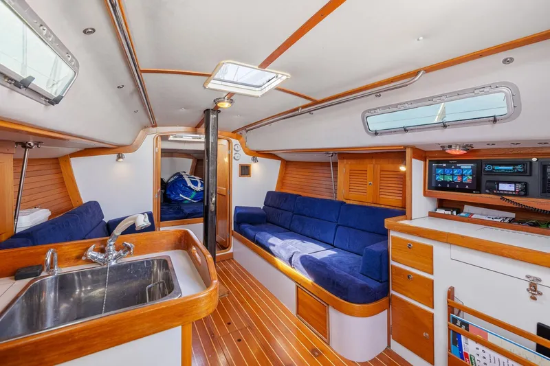Slide: The Image of Interior of 2005 J Boats J/124 sailboat with blue seating, wood accents, and modern amenities. - 30