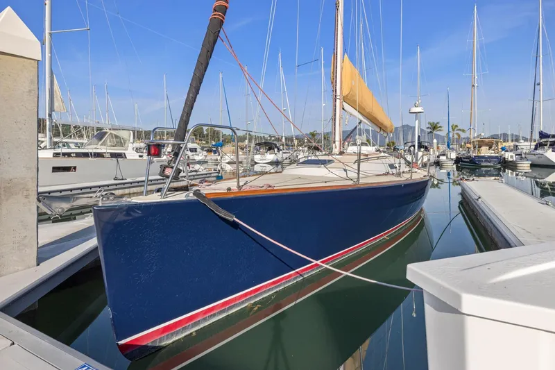 Slide: The Image of 2005 J Boats J/124 sailboat docked in a marina, featuring a sleek blue hull. - 8