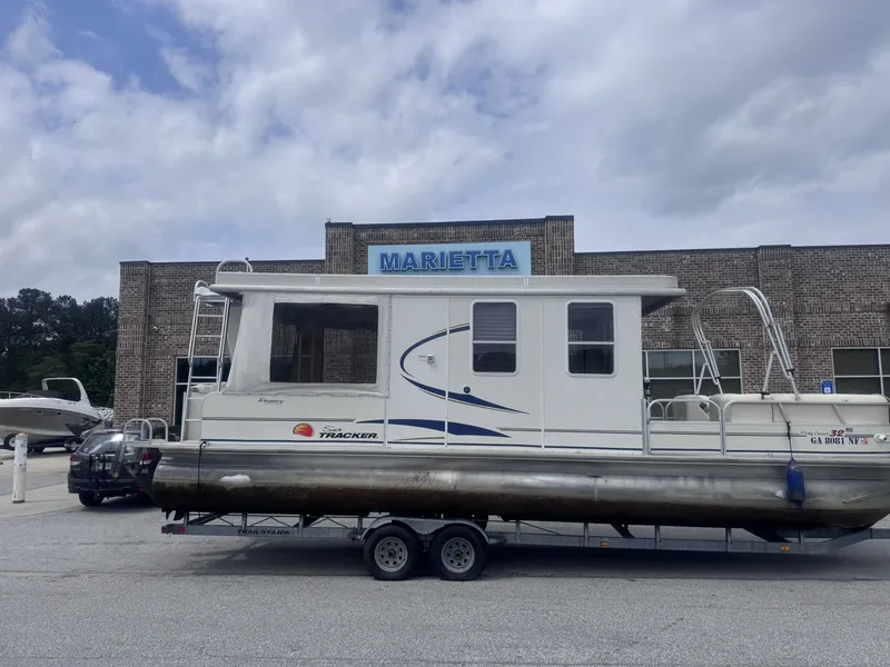 Slide: The Image of 2008 Sun Tracker Party Cruiser 32 with trailer in front of Marietta building. - 6