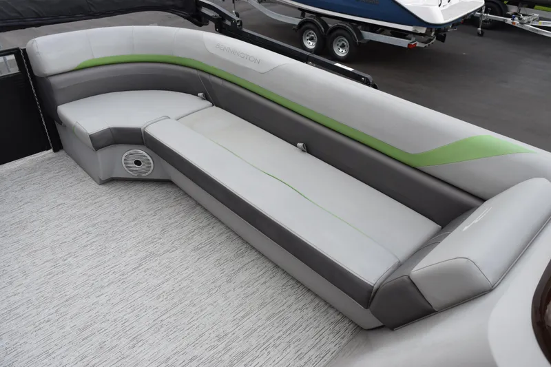 Slide: The Image of 2021 Bennington 24 SSBX pontoon boat interior with gray and green seating. - 11