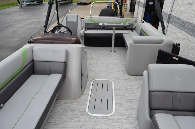 Slide: The Image of 2021 Bennington 24 SSBX pontoon boat interior with gray seating and steering console. - 13