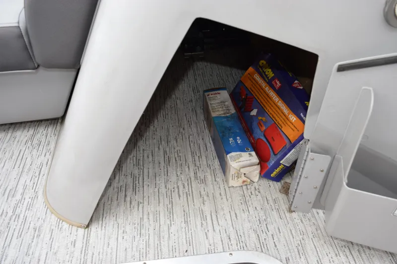 Slide: The Image of Storage compartment on a 2021 Bennington 24 SSBX boat with safety equipment. - 15