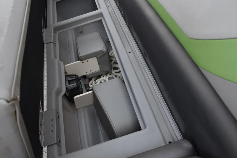 Slide: The Image of Storage compartment in a 2021 Bennington 24 SSBX boat, featuring ropes and equipment. - 16