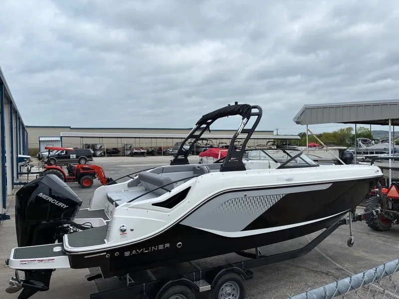 Slide: The Image of Bayliner D22 2026 motorboat on trailer outdoors. - 10