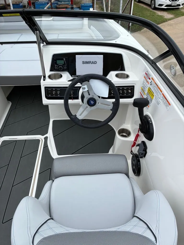 Slide: The Image of Interior view of Bayliner D22 boat, 2026 model, featuring modern helm console. - 11
