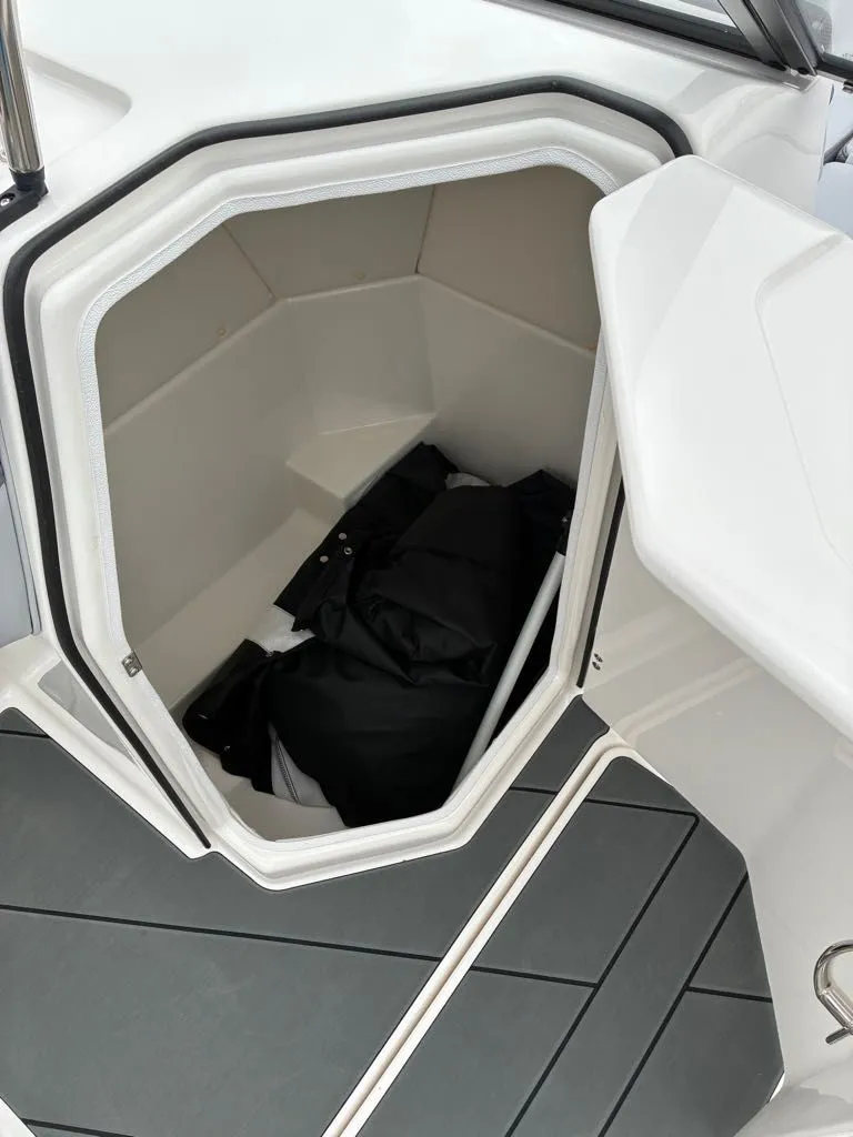 Slide: The Image of Interior of 2026 Bayliner D22 with storage compartment and clothing. - 12