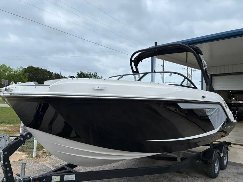 Slide: The Image of 2026 Bayliner D22 boat on trailer, black and white design. - 13