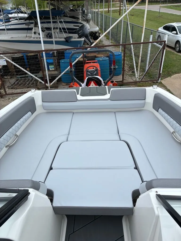 Slide: The Image of Interior of a 2026 Bayliner D22 boat with gray upholstery. - 15