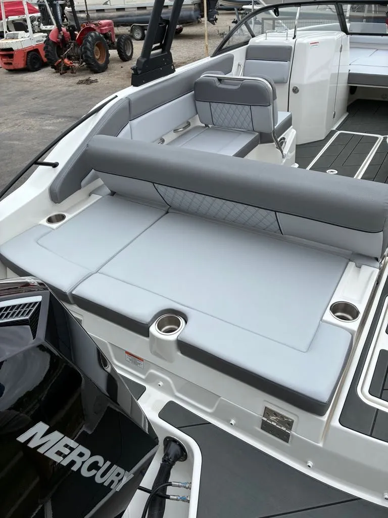 Slide: The Image of Interior of a 2026 Bayliner D22 boat with gray seating. - 17