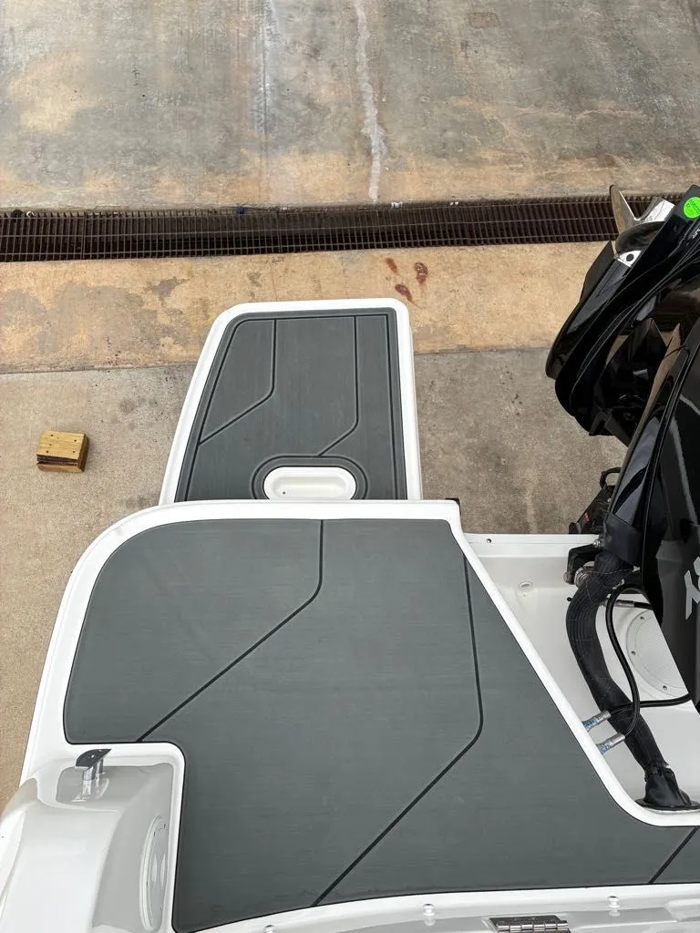 Slide: The Image of Bayliner D22 2026 boat rear with gray deck flooring. - 6