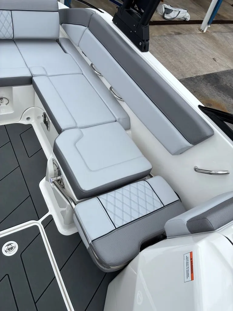 Slide: The Image of Interior of Bayliner D22 boat, gray upholstery, model year 2026. - 8