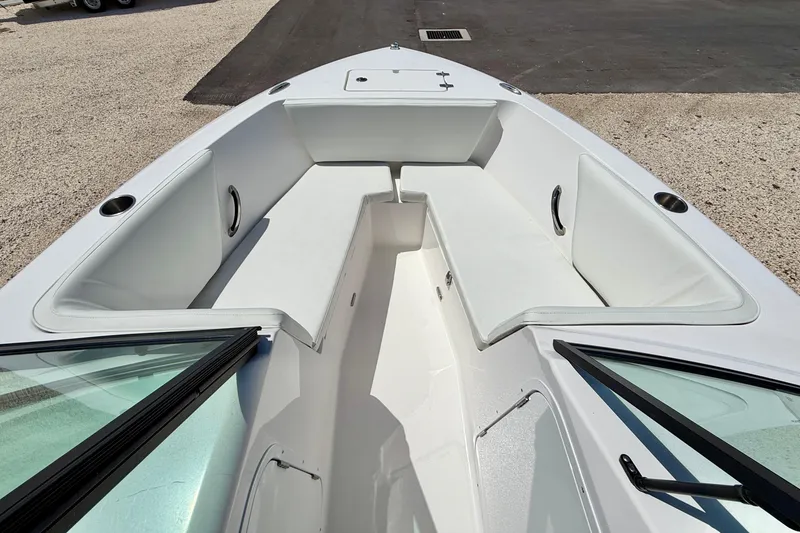 Slide: The Image of 2023 Aquasport 2200 Dual Console boat interior with white seating and windshield. - 10
