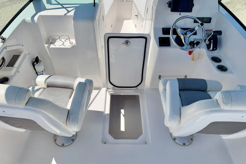 Slide: The Image of 2023 Aquasport 2200 Dual Console interior with steering wheel and seating arrangement. - 25