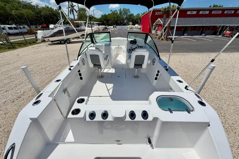 Slide: The Image of 2023 Aquasport 2200 Dual Console boat interior with seating and fishing amenities. - 26