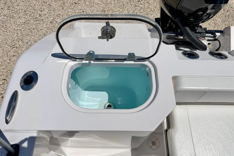 Slide: The Image of 2023 Aquasport 2200 Dual Console boat with open livewell and motor detail. - 28