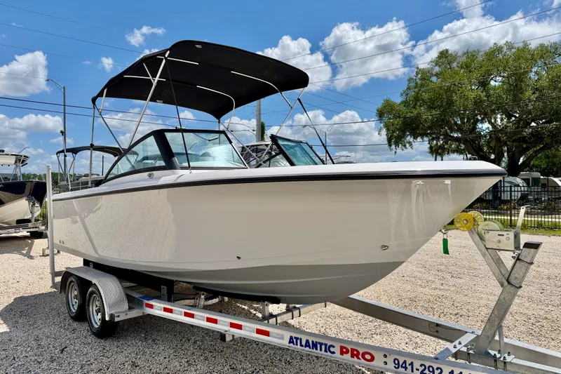 Slide: The Image of 2023 Aquasport 2200 Dual Console boat on trailer under blue sky. - 3