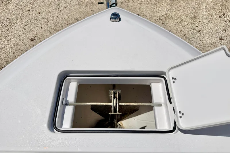 Slide: The Image of 2023 Aquasport 2200 Dual Console anchor compartment with open hatch. - 31