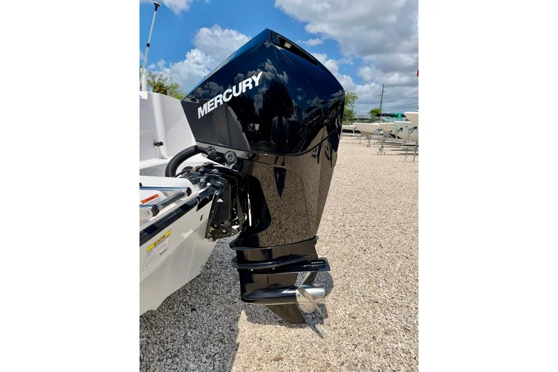 Slide: The Image of 2023 Aquasport 2200 Dual Console with Mercury outboard engine on gravel lot. - 34