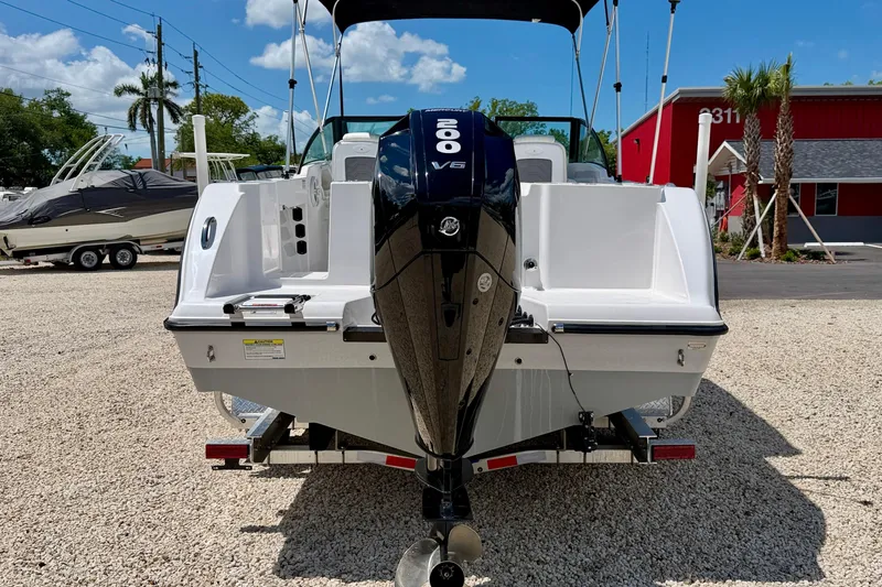 Slide: The Image of 2023 Aquasport 2200 Dual Console boat with powerful V6 engine, parked outdoors. - 6