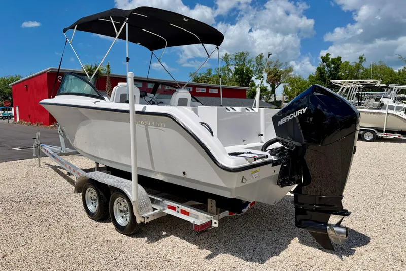 Slide: The Image of 2023 Aquasport 2200 Dual Console boat on trailer with Mercury outboard motor. - 7