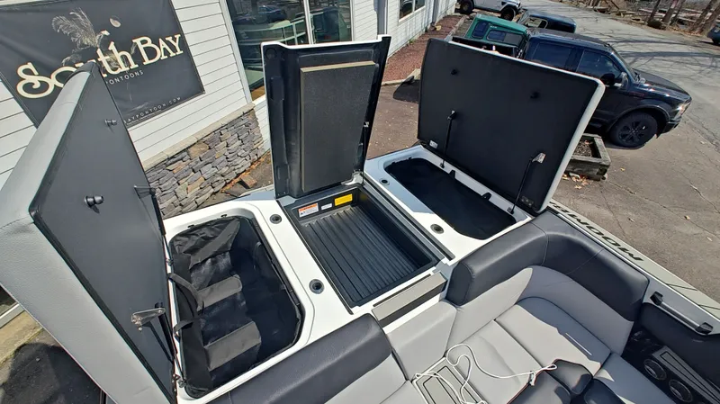 Slide: The Image of Moomba Max 2026 boat with open storage compartments and seating area. - 17