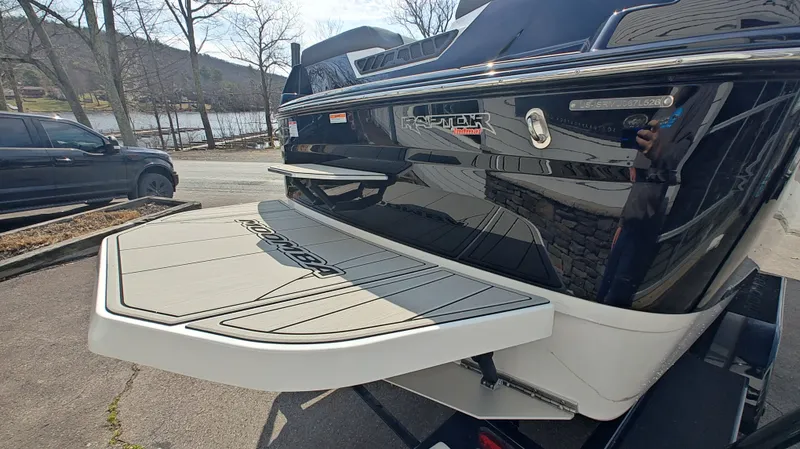 Slide: The Image of Rear view of a 2026 Moomba Max boat by the lake. - 4