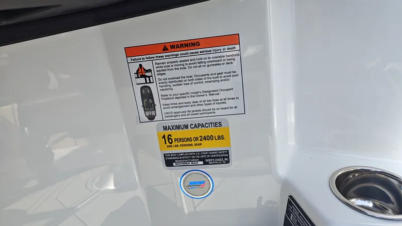 Slide: The Image of Warning label on Moomba Max 2026 boat with capacity details. - 6