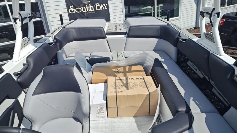 Slide: The Image of Interior of a 2026 Moomba Max boat with boxes. - 8