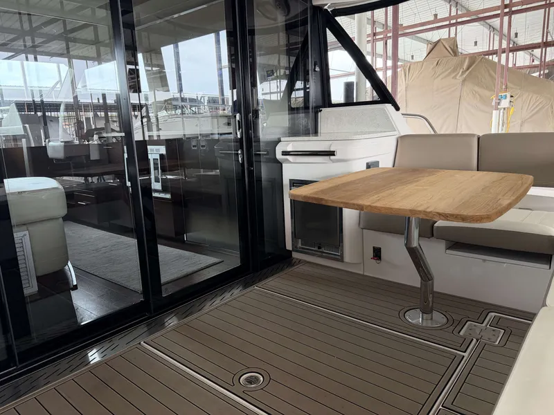 Slide: The Image of Interior of a 2017 Regal 42 Grande Coupe yacht with wooden table. - 16