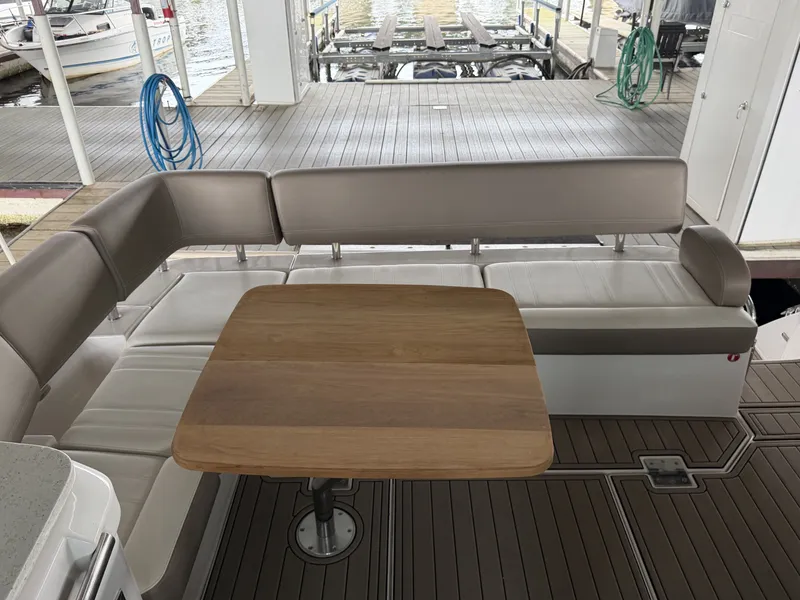 Slide: The Image of Interior of 2017 Regal 42 Grande Coupe with wooden table and seating area. - 18