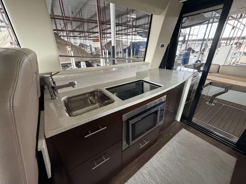 Slide: The Image of Interior of 2017 Regal 42 Grande Coupe featuring modern kitchen. - 25