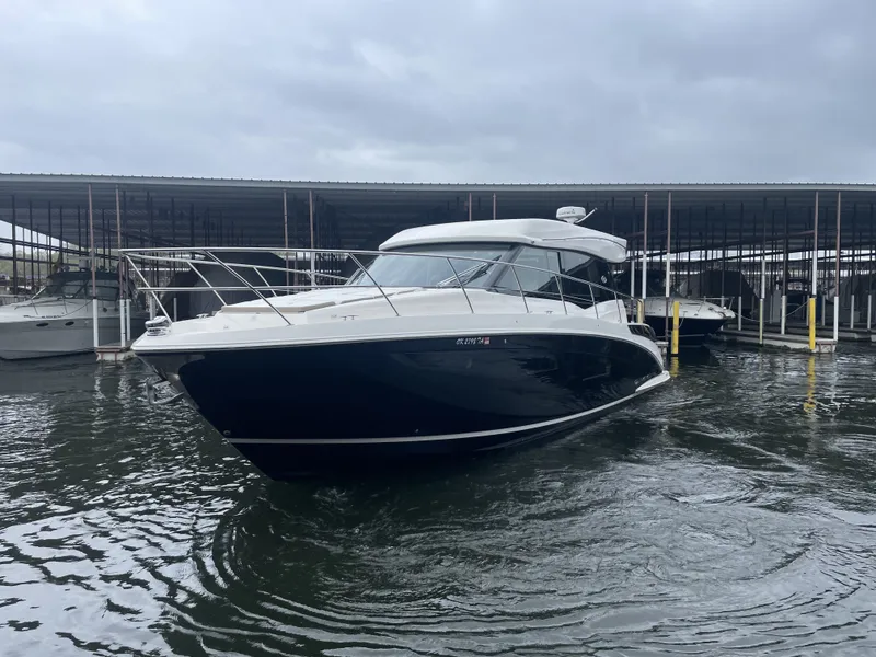 Slide: The Image of 2017 Regal 42 Grande Coupe docked under cloudy skies. - 5