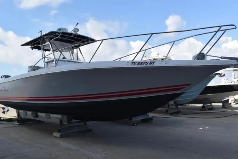 The Image of 2001 Pro-Line 3400 Bimini Cuddy boat on dry dock, featuring sleek design and sturdy build. - 0
