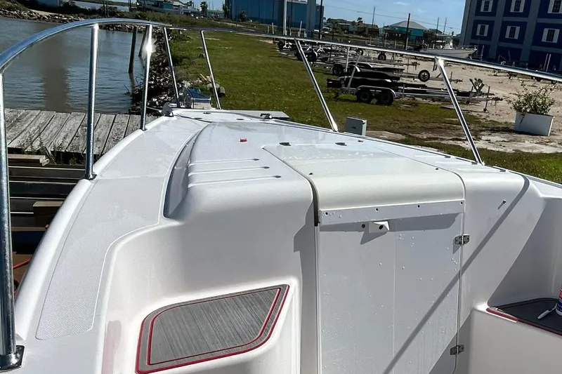Slide: The Image of 2001 Pro-Line 3400 Bimini Cuddy boat docked near a waterfront with trailers in view. - 10