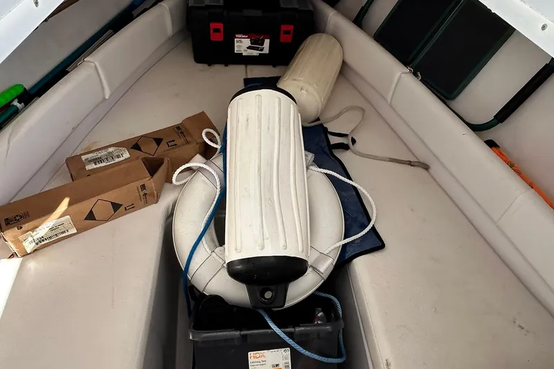 Slide: The Image of Interior of 2001 Pro-Line 3400 Bimini Cuddy with boat accessories and storage boxes. - 11