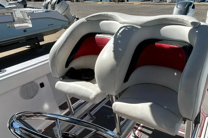 Slide: The Image of 2001 Pro-Line 3400 Bimini Cuddy boat seats with red and white upholstery. - 15