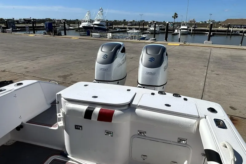 Slide: The Image of 2001 Pro-Line 3400 Bimini Cuddy boat with dual Suzuki 350 engines at marina. - 16