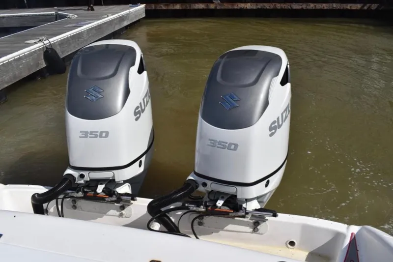 Slide: The Image of Twin Suzuki 350 outboard engines on a 2001 Pro-Line 3400 Bimini Cuddy boat. - 17