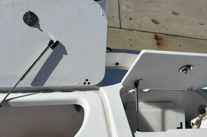 Slide: The Image of Open storage compartments on a 2001 Pro-Line 3400 Bimini Cuddy boat deck. - 18