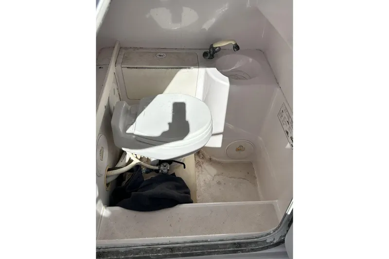 Slide: The Image of 2001 Pro-Line 3400 Bimini Cuddy boat interior with toilet and sink. - 19