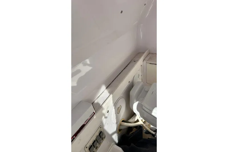 Slide: The Image of Interior view of a 2001 Pro-Line 3400 Bimini Cuddy boat, showcasing storage and utility features. - 21