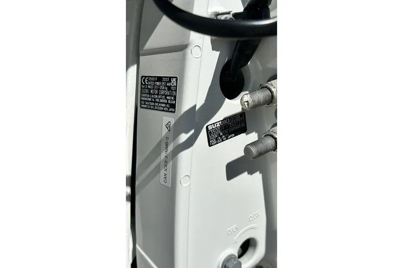 Slide: The Image of Close-up of a 2001 Pro-Line 3400 Bimini Cuddy boat engine details and labels. - 23